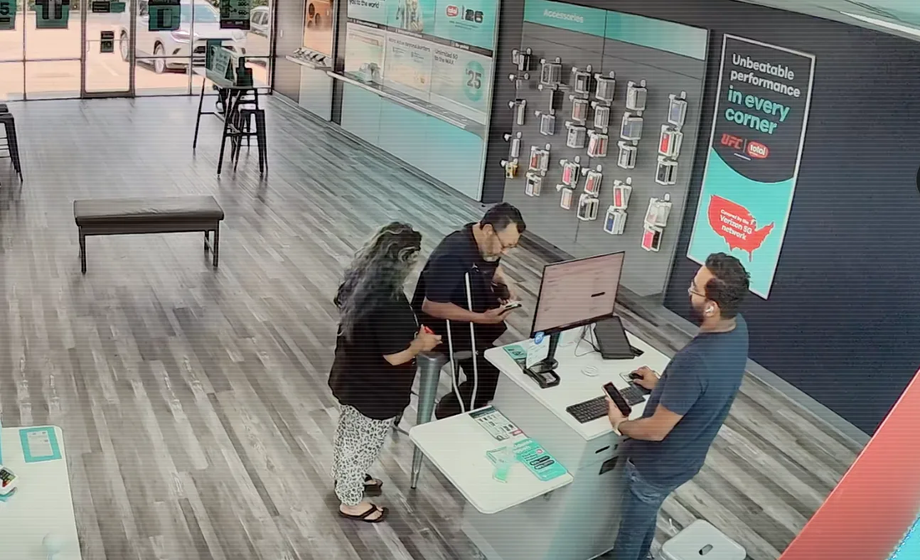 Surveillance view of a customer interaction at the Peachtree Blvd store